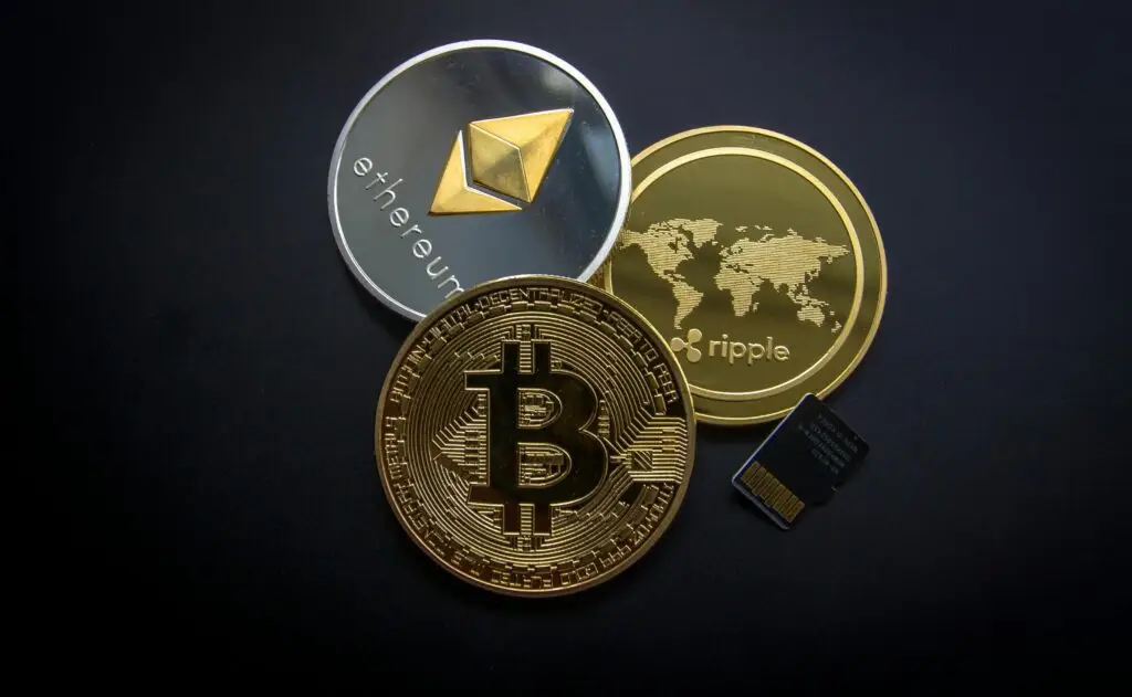 Gold Bitcoin (BTC), silver Ethereum (ETH), and Ripple coins with a microchip, symbolizing digital assets and the financial data required for calculating crypto P&L and accurate Cost Basis.